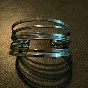 Silver tone cuff bracelet.